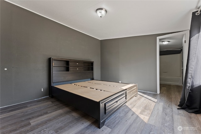 bedroom with dark hardwood / wood-style flooring