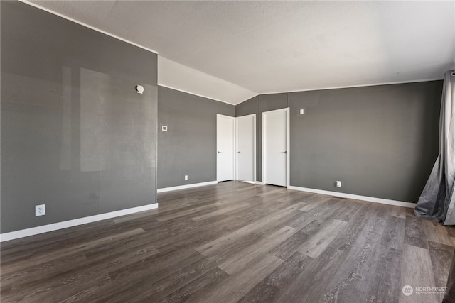 unfurnished room featuring lofted ceiling and hardwood / wood-style floors