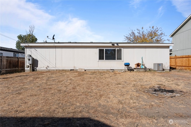 rear view of property with central AC unit