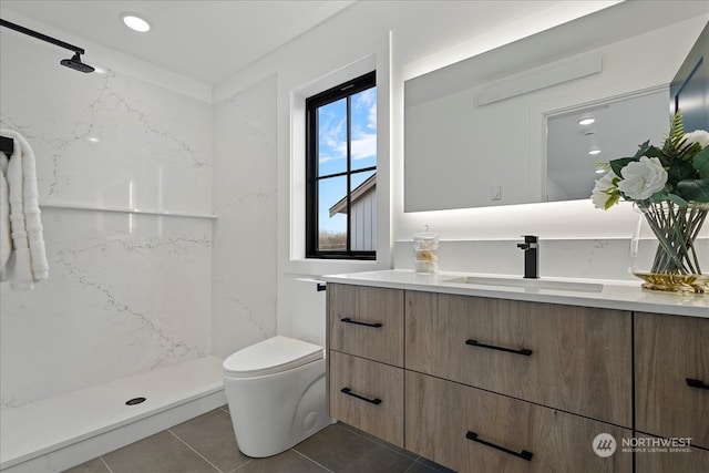 bathroom with tile patterned floors, vanity, toilet, and a shower