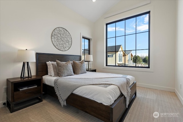 bedroom featuring vaulted ceiling and light colored carpet