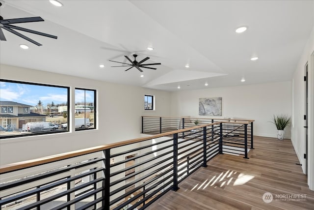 hallway with hardwood / wood-style flooring and lofted ceiling