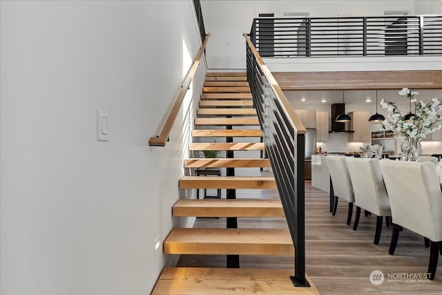 staircase with hardwood / wood-style flooring