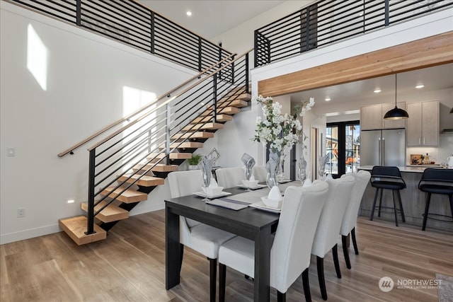 dining room with light wood-type flooring and french doors