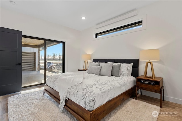 bedroom with access to outside and light hardwood / wood-style flooring