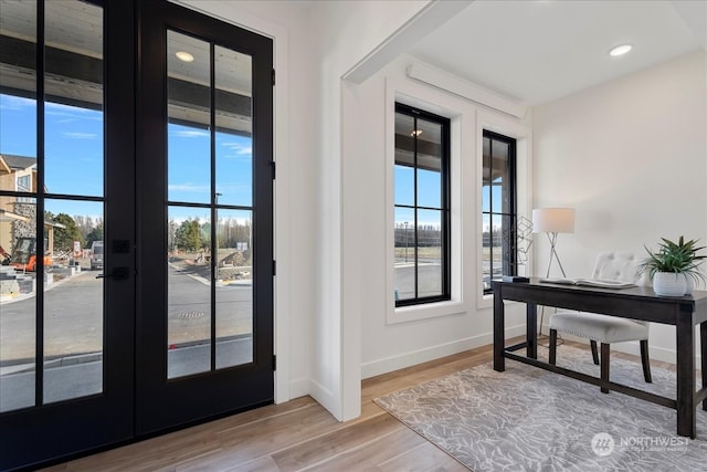 doorway to outside with hardwood / wood-style flooring, a healthy amount of sunlight, and french doors