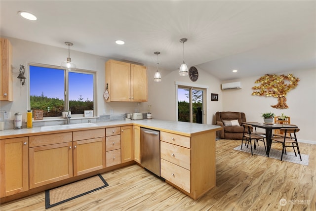 kitchen with a wall unit AC, kitchen peninsula, hanging light fixtures, and light hardwood / wood-style floors