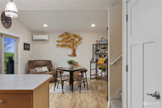 dining area featuring light hardwood / wood-style flooring and a wall mounted AC