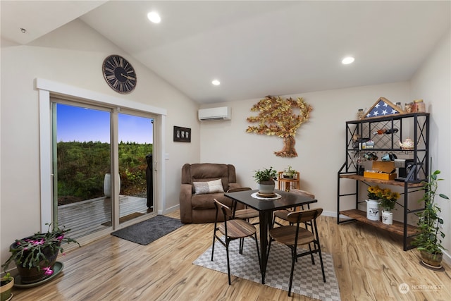 interior space featuring light hardwood / wood-style floors, an AC wall unit, and vaulted ceiling