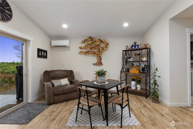 dining area featuring hardwood / wood-style flooring and an AC wall unit