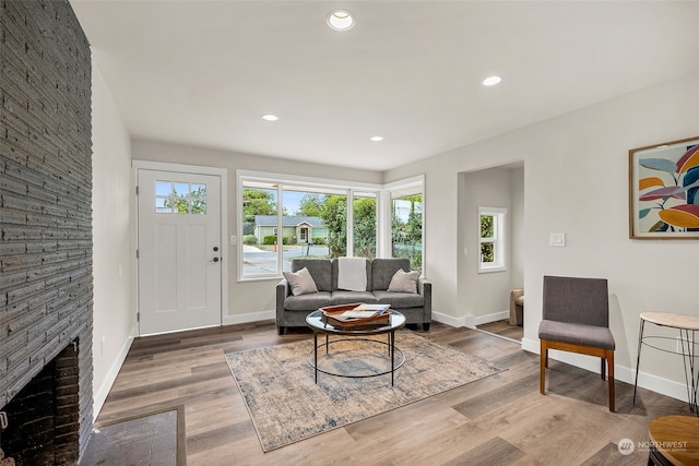 living room with hardwood / wood-style flooring, a fireplace, and a wealth of natural light