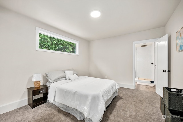 bedroom featuring carpet flooring and ensuite bath