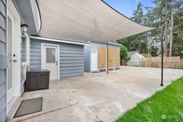 view of patio featuring a storage unit