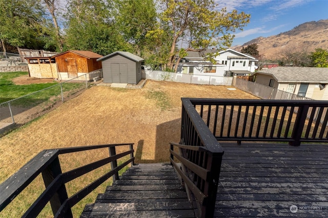 260 Chestnut St, Chelan Falls, WA 98817 - deck with a fenced backyard, a mountain view, an outbuilding, and a storage shed