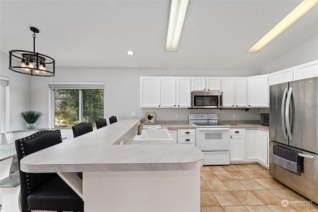 260 Chestnut St, Chelan Falls, WA 98817 - kitchen featuring stainless steel appliances, an inviting chandelier, light countertops, a sink, and a peninsula