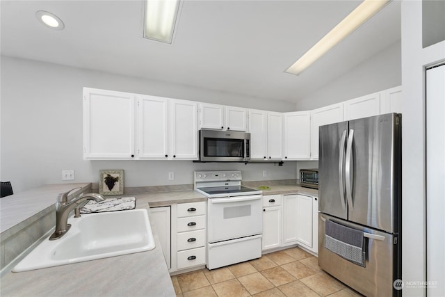 260 Chestnut St, Chelan Falls, WA 98817 - kitchen featuring a sink, white cabinetry, lofted ceiling, light countertops, and appliances with stainless steel finishes