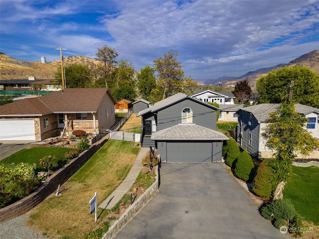 260 Chestnut St, Chelan Falls, WA 98817 - view of front facade featuring fence, a front lawn, a residential view, a mountain view, and a garage