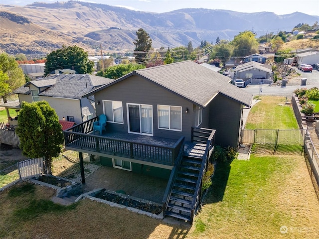 260 Chestnut St, Chelan Falls, WA 98817 - view of front of home featuring a fenced backyard, a deck with mountain view, stairs, and a front yard