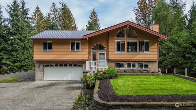 bi-level home featuring a front yard and a garage