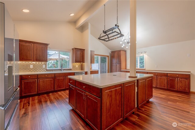 kitchen featuring tasteful backsplash, a kitchen island, dark hardwood / wood-style flooring, a notable chandelier, and high vaulted ceiling