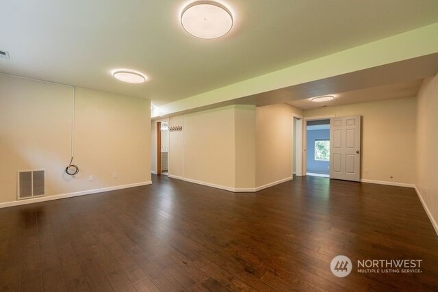 spare room featuring dark wood-type flooring