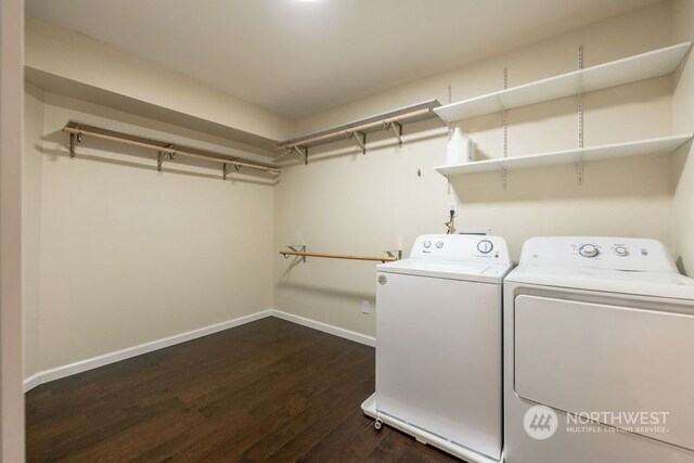 laundry area featuring washing machine and dryer and dark hardwood / wood-style flooring