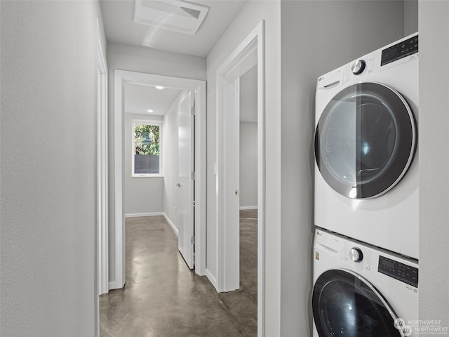 laundry room featuring stacked washer / drying machine