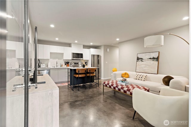 living room with recessed lighting and finished concrete floors