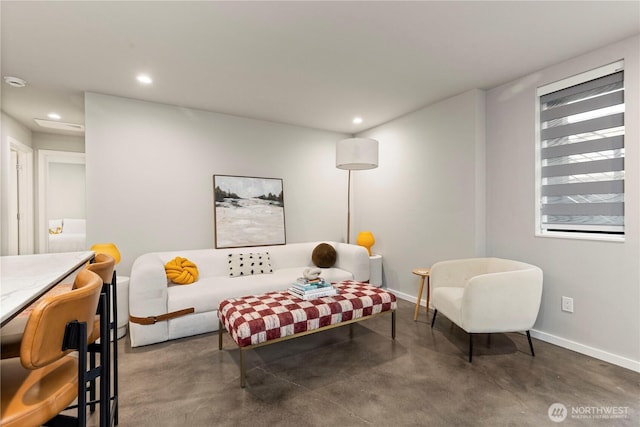 living room with baseboards, concrete floors, and recessed lighting