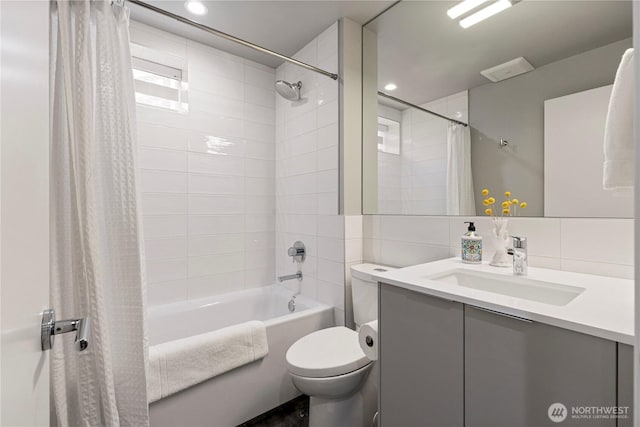 bathroom featuring toilet, vanity, tile walls, decorative backsplash, and shower / bathtub combination with curtain