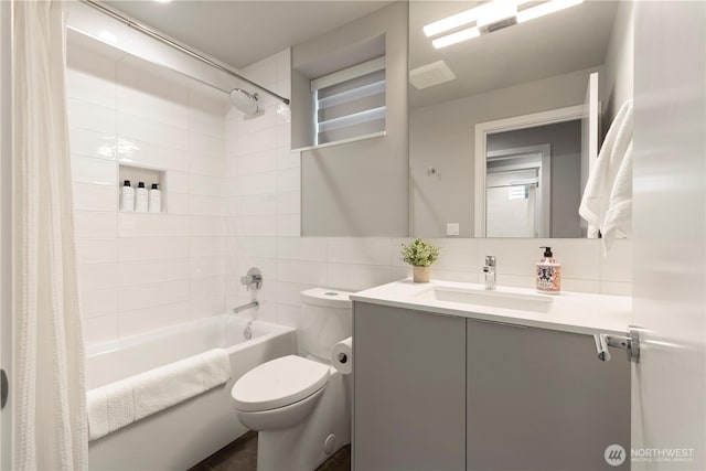 full bathroom featuring shower / tub combo with curtain, tile walls, decorative backsplash, toilet, and vanity