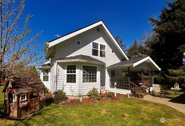 view of front of property with a front yard and a porch