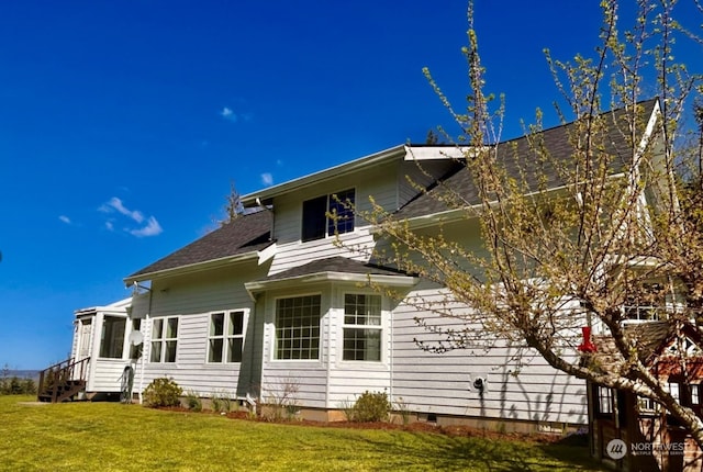 view of property exterior with a yard