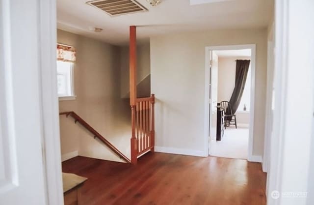 corridor with hardwood / wood-style floors