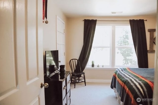 bedroom with multiple windows and carpet floors