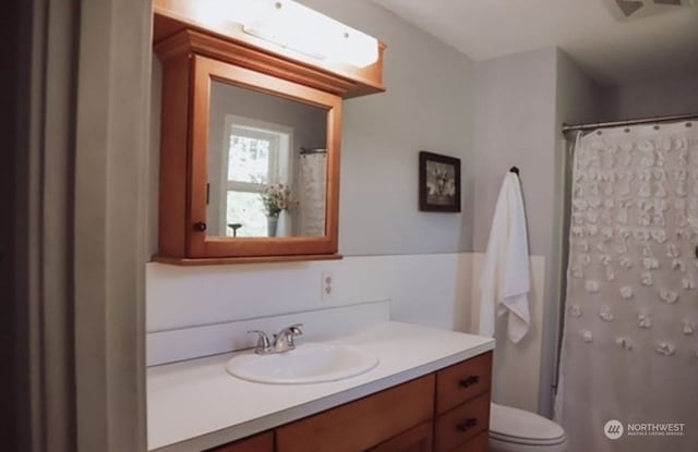 bathroom featuring vanity and toilet