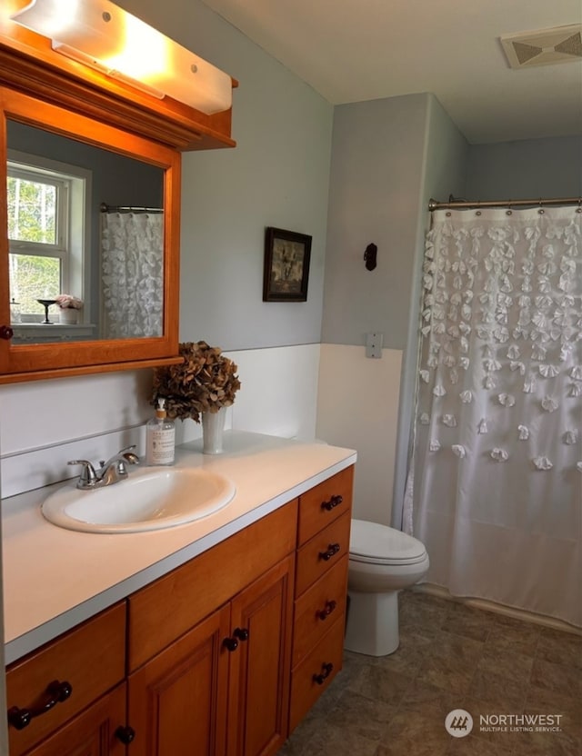 bathroom with vanity and toilet