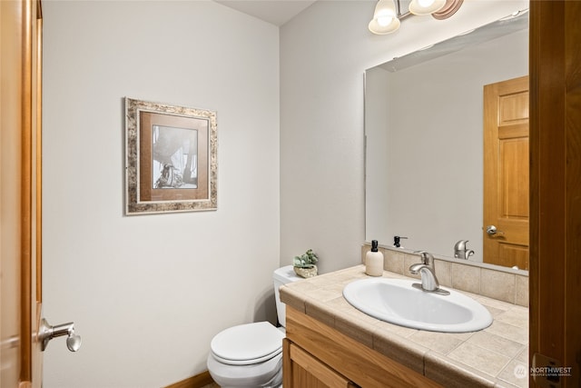 bathroom featuring toilet and vanity