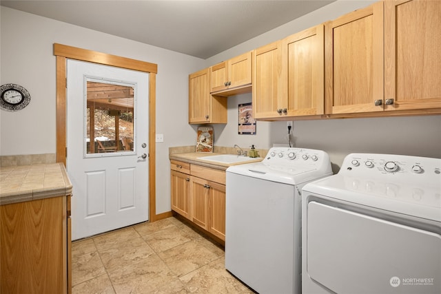 laundry room featuring a sink, cabinet space, and washer and dryer