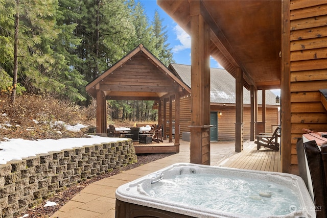 view of patio with a gazebo, a hot tub, and a wooden deck