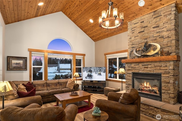 living room featuring a notable chandelier, wood ceiling, a stone fireplace, wood finished floors, and high vaulted ceiling