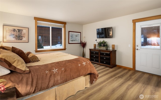 bedroom featuring wood finished floors and baseboards