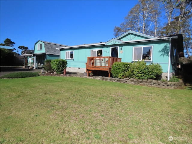 back of property featuring a deck and a yard