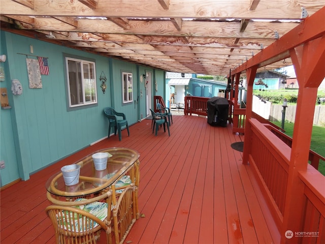 deck with a pergola and grilling area