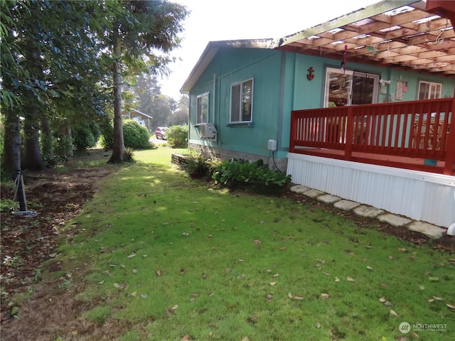 view of home's exterior featuring a lawn, a deck, and a pergola