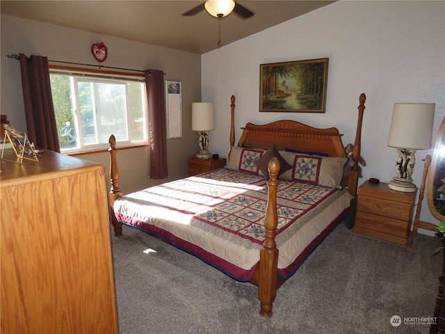 bedroom featuring lofted ceiling, dark carpet, and ceiling fan