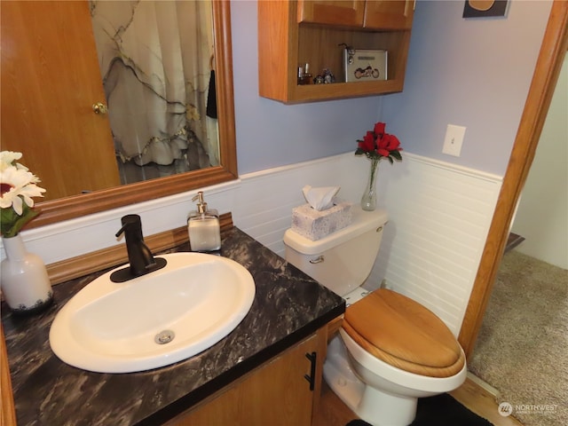 bathroom featuring vanity and toilet