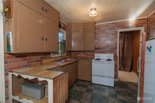 kitchen with sink, brick wall, and white appliances