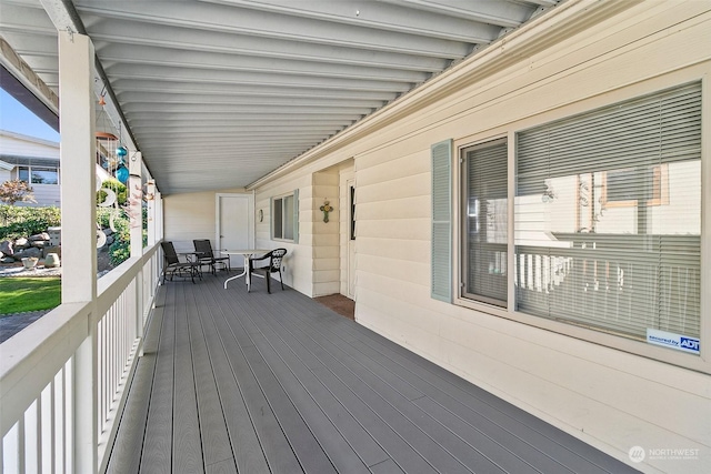 wooden terrace with outdoor dining space