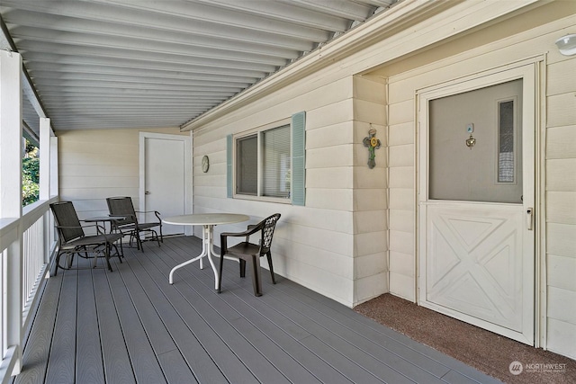 wooden deck featuring outdoor dining area